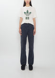 Front view of a model wearing the Visvim navy Fluxus Boot Cut Pant with a graphic t-shirt.