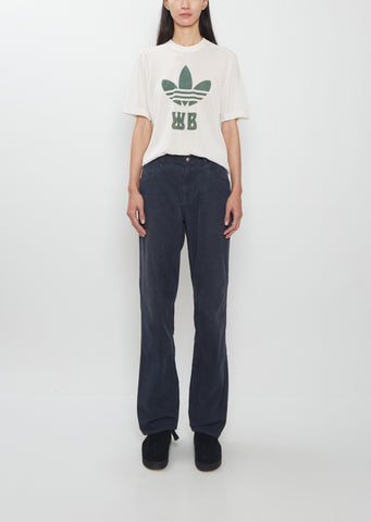 Front view of a model wearing the Visvim navy Fluxus Boot Cut Pant with a graphic t-shirt.
