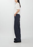 Side view of a person wearing the Visvim Fluxus Boot Cut Pant in navy.