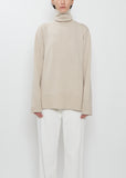 Front view of The Row Stepny Wool Cashmere Top in sand beige with a turtleneck.
