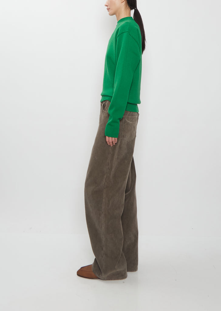 Side view of the Auralee Super Fine Wool Knit Pullover in green.