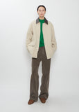 Front view of the Auralee Homespun Tweed Zip Blouson in Ivory Beige worn by a model.