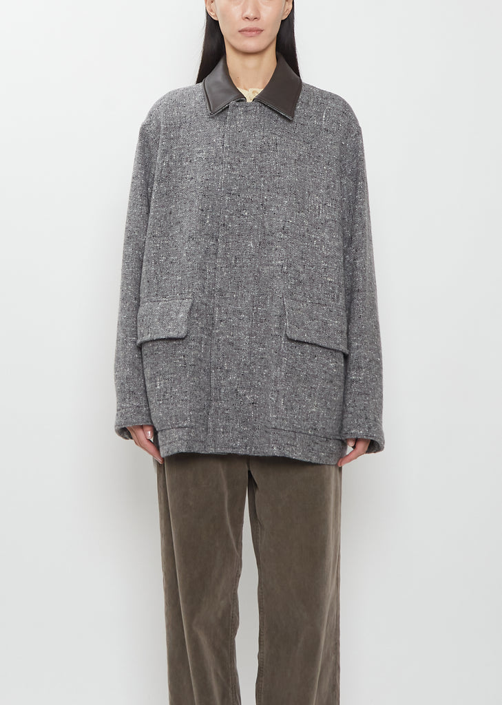 Front view of the Auralee Homespun Tweed Zip Blouson in Mix Gray on a model.
