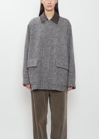 Front view of the Auralee Homespun Tweed Zip Blouson in Mix Gray on a model.