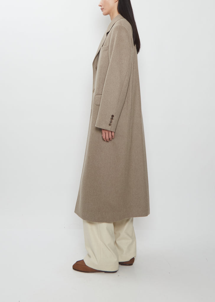 Profile view of Auralee Cashmere Moleskin Long Coat in beige.