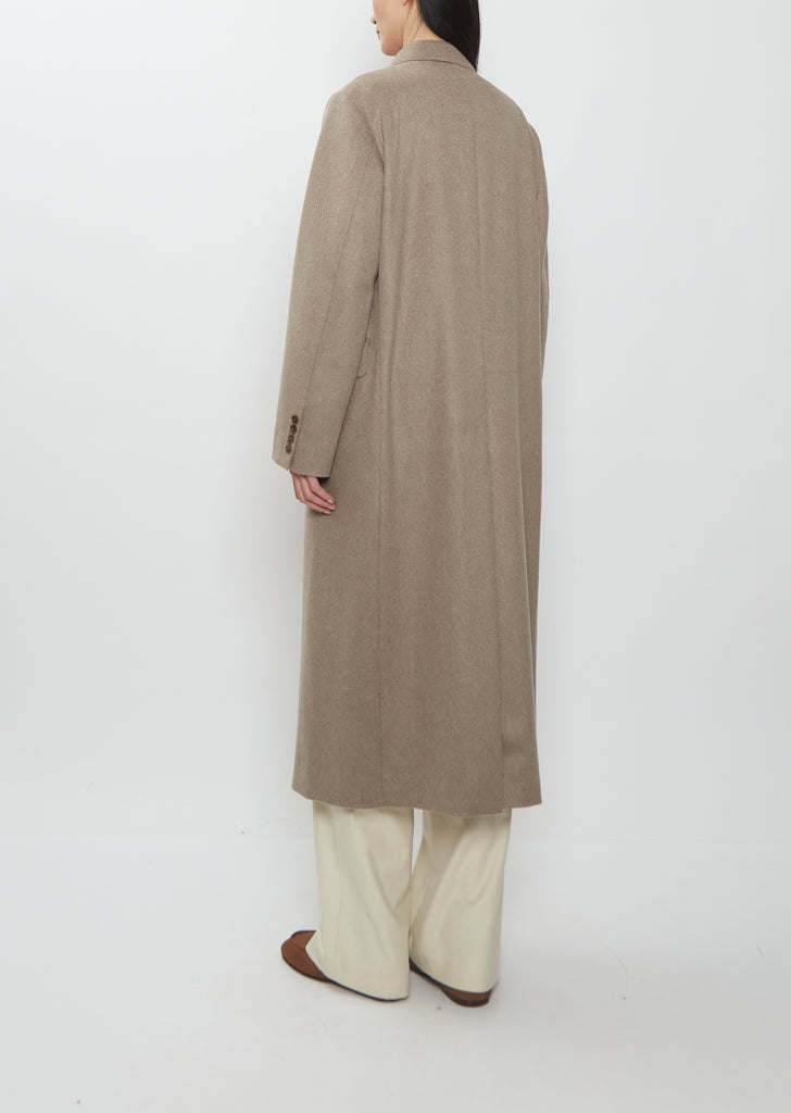 Rear view of Auralee cashmere moleskin long coat in beige.