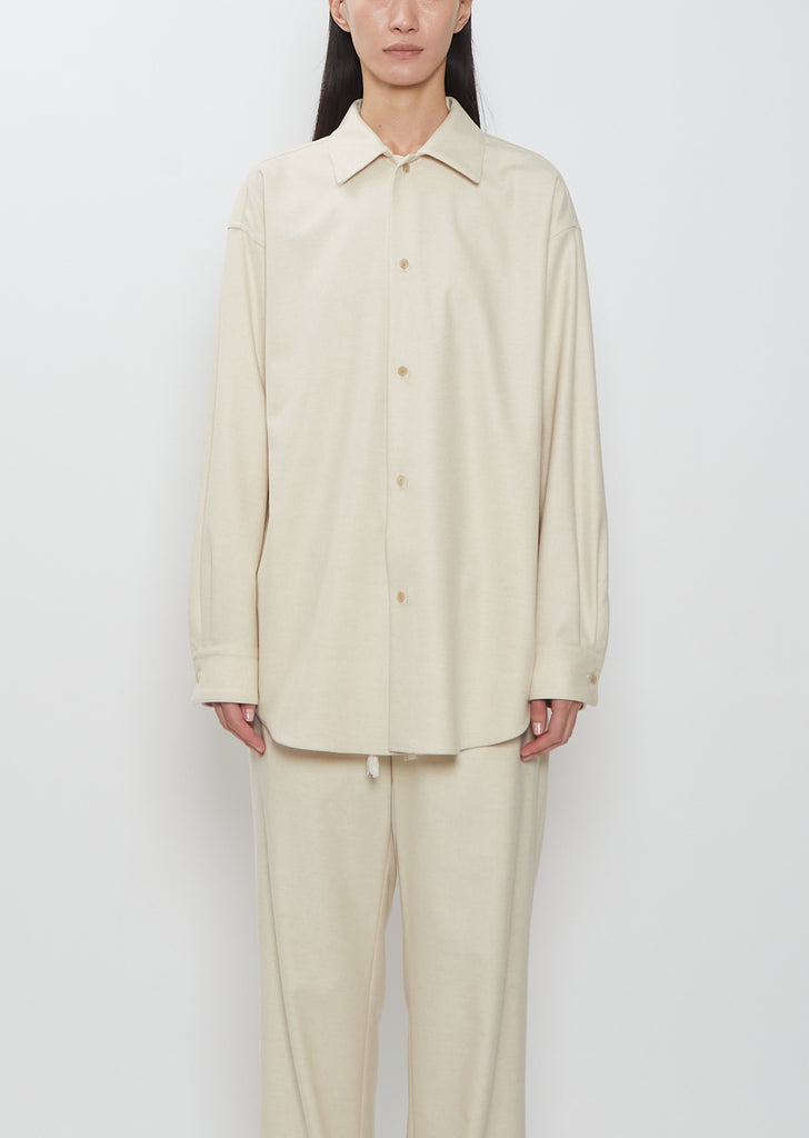 Front view of a model wearing the Auralee Wool Fulling Flannel Shirt in Top Ivory.