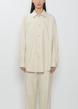 Front view of a model wearing the Auralee Wool Fulling Flannel Shirt in Top Ivory.