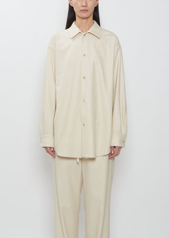 Front view of a model wearing the Auralee Wool Fulling Flannel Shirt in Top Ivory.