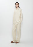 Full-length view of the Auralee Wool Fulling Flannel Shirt in Top Ivory worn with matching trousers.